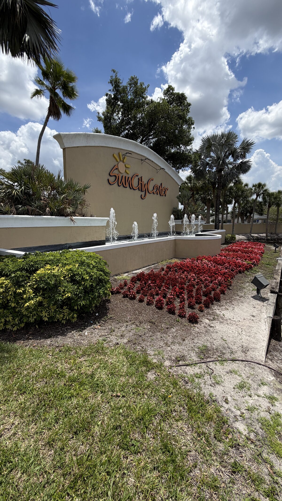 Kings Point entrance with red flowers